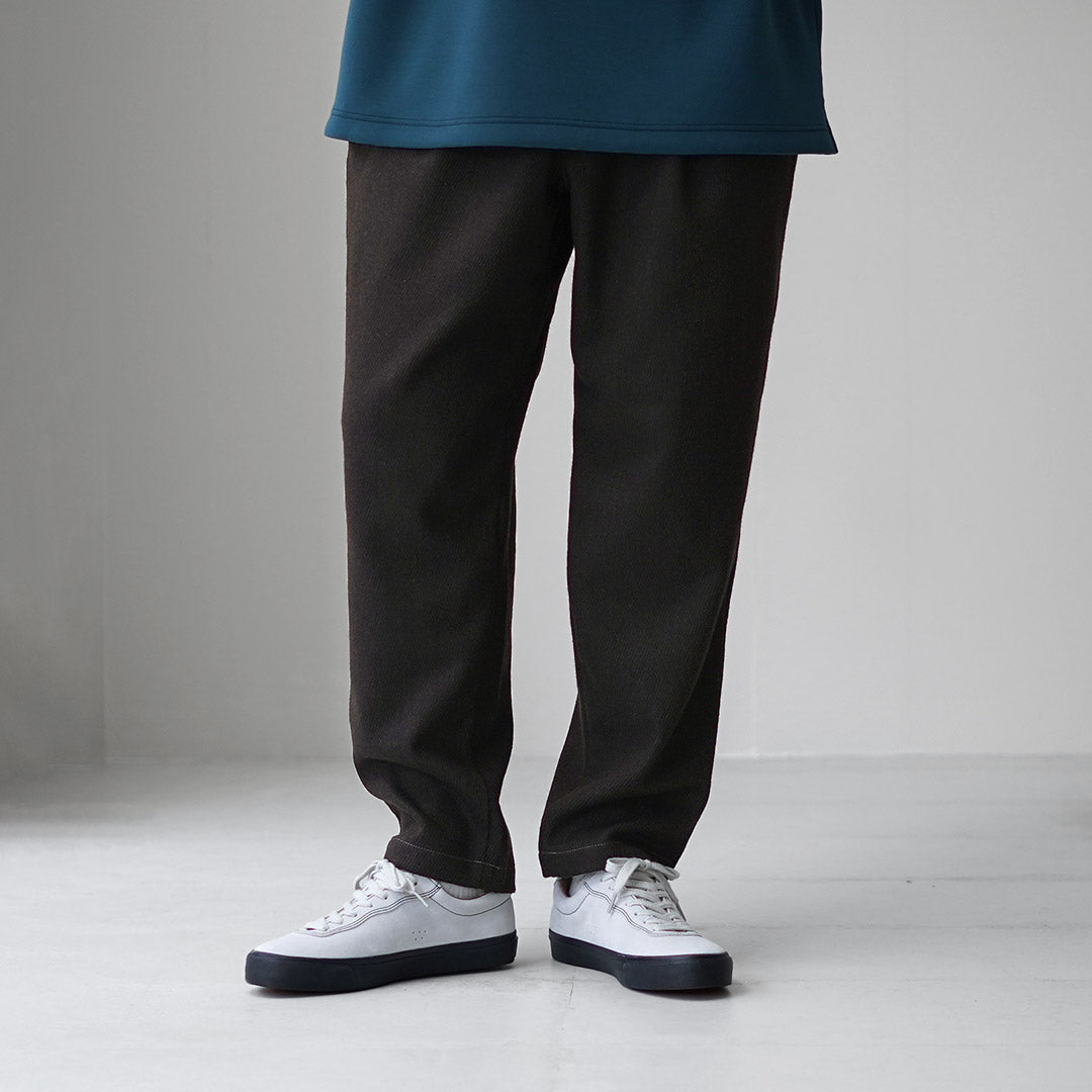 AND WANDER / REWOOL Pantalon fuselé en tweed